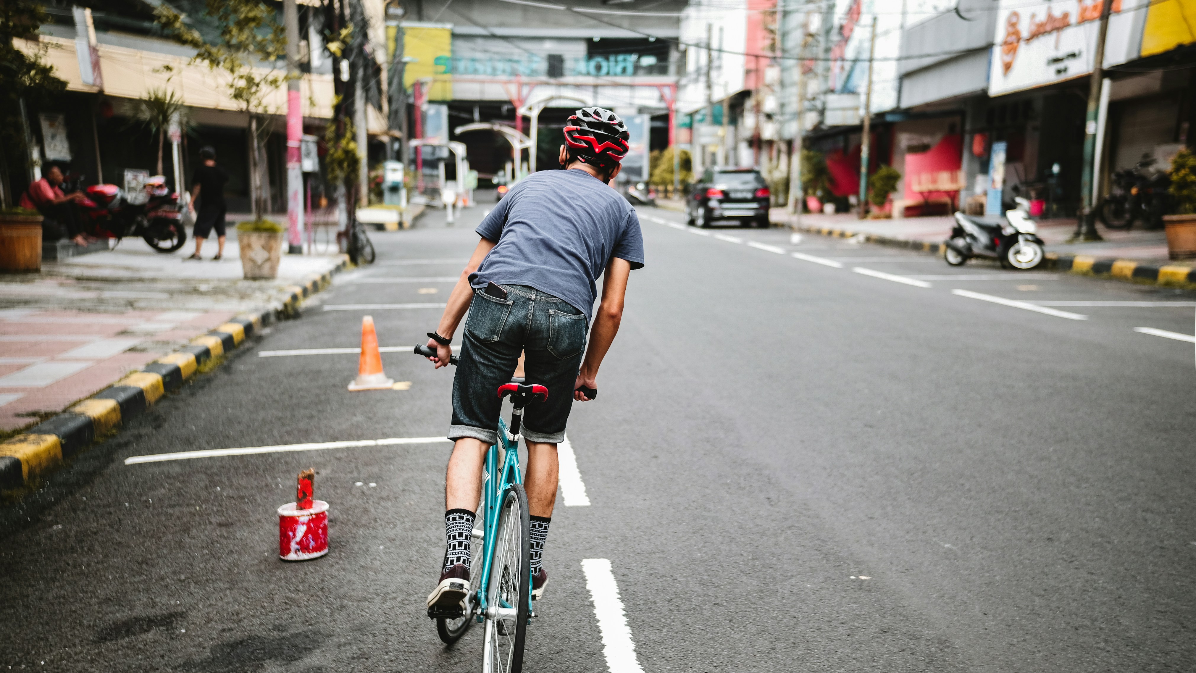 Cyclist riding a road bike outdoors in real conditions.