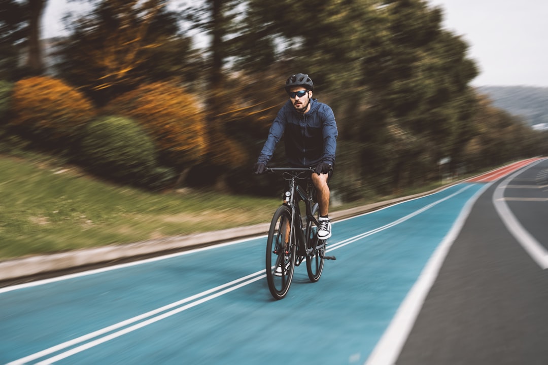 Group of road cyclists riding together outdoors on paved roads.