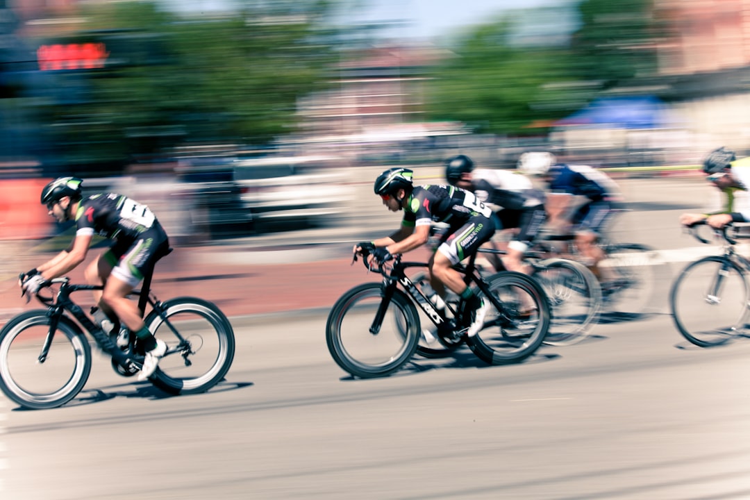 Group of road cyclists riding together outdoors on paved roads.