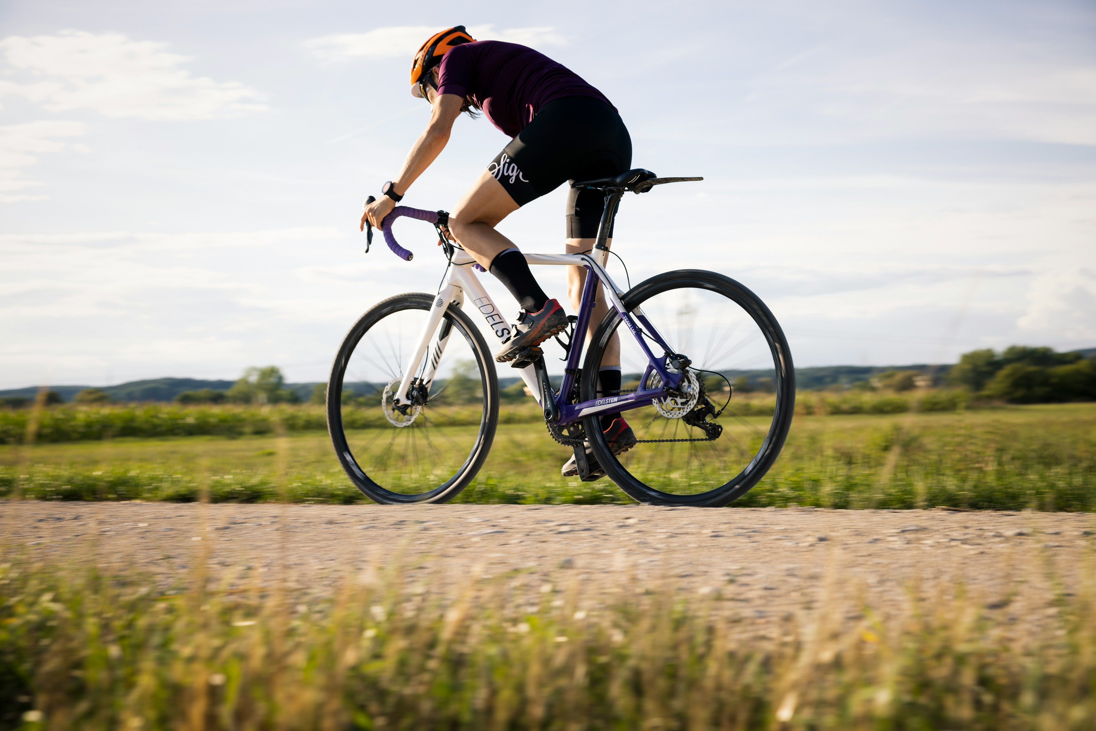 Cyclist riding a road bike outdoors in real conditions.