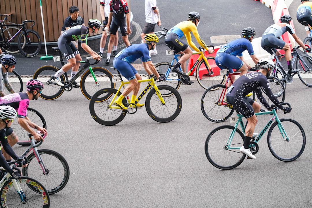 Group of road cyclists riding together outdoors on paved roads.