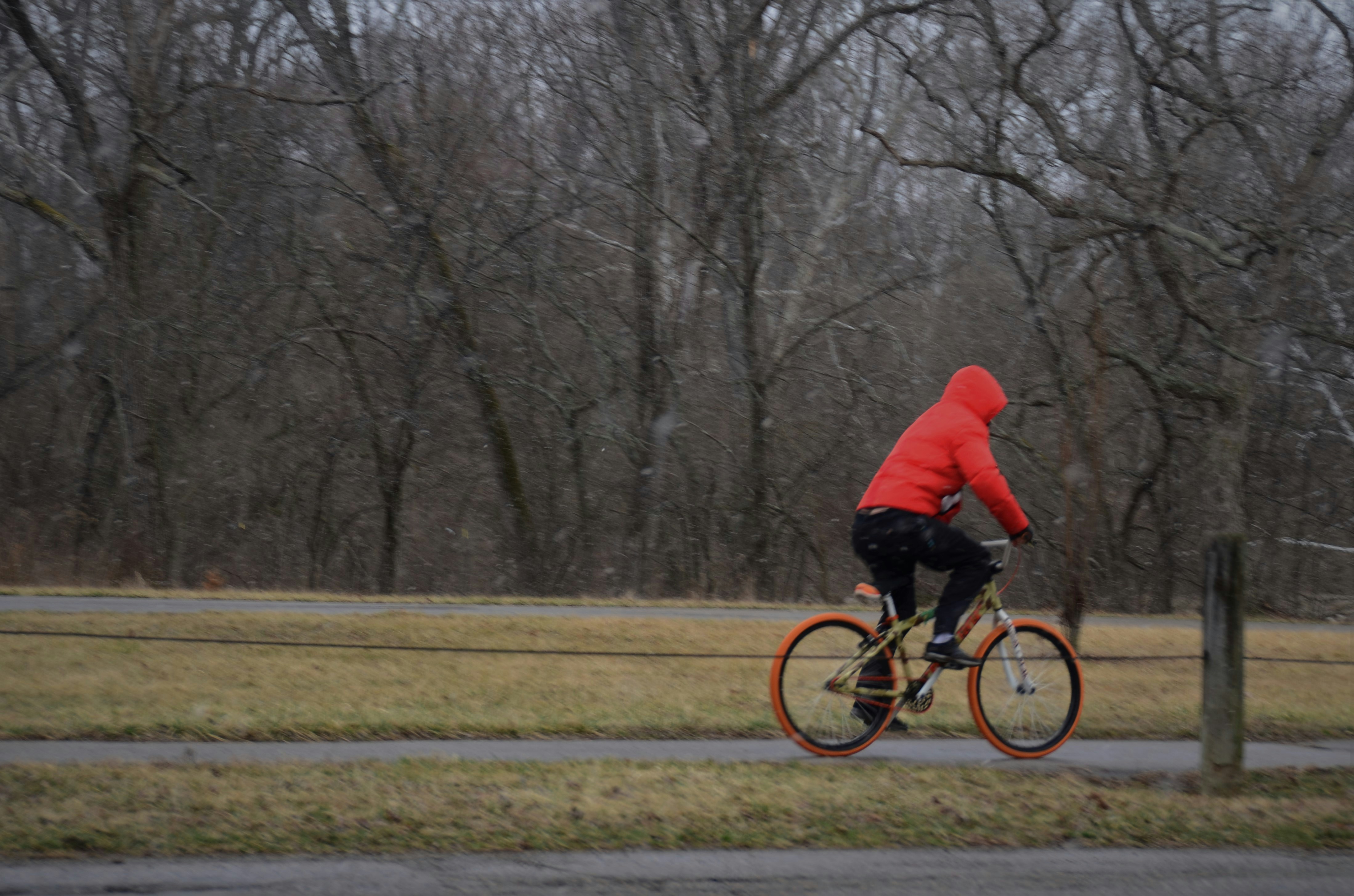 Cyclist riding a road bike outdoors in real conditions.