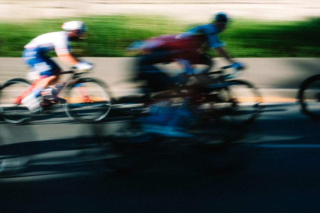 Group of road cyclists riding together outdoors on paved roads.