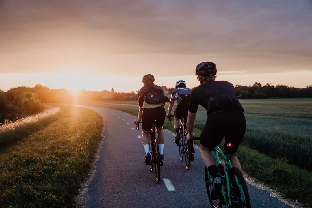 Group of road cyclists riding together outdoors on paved roads.
