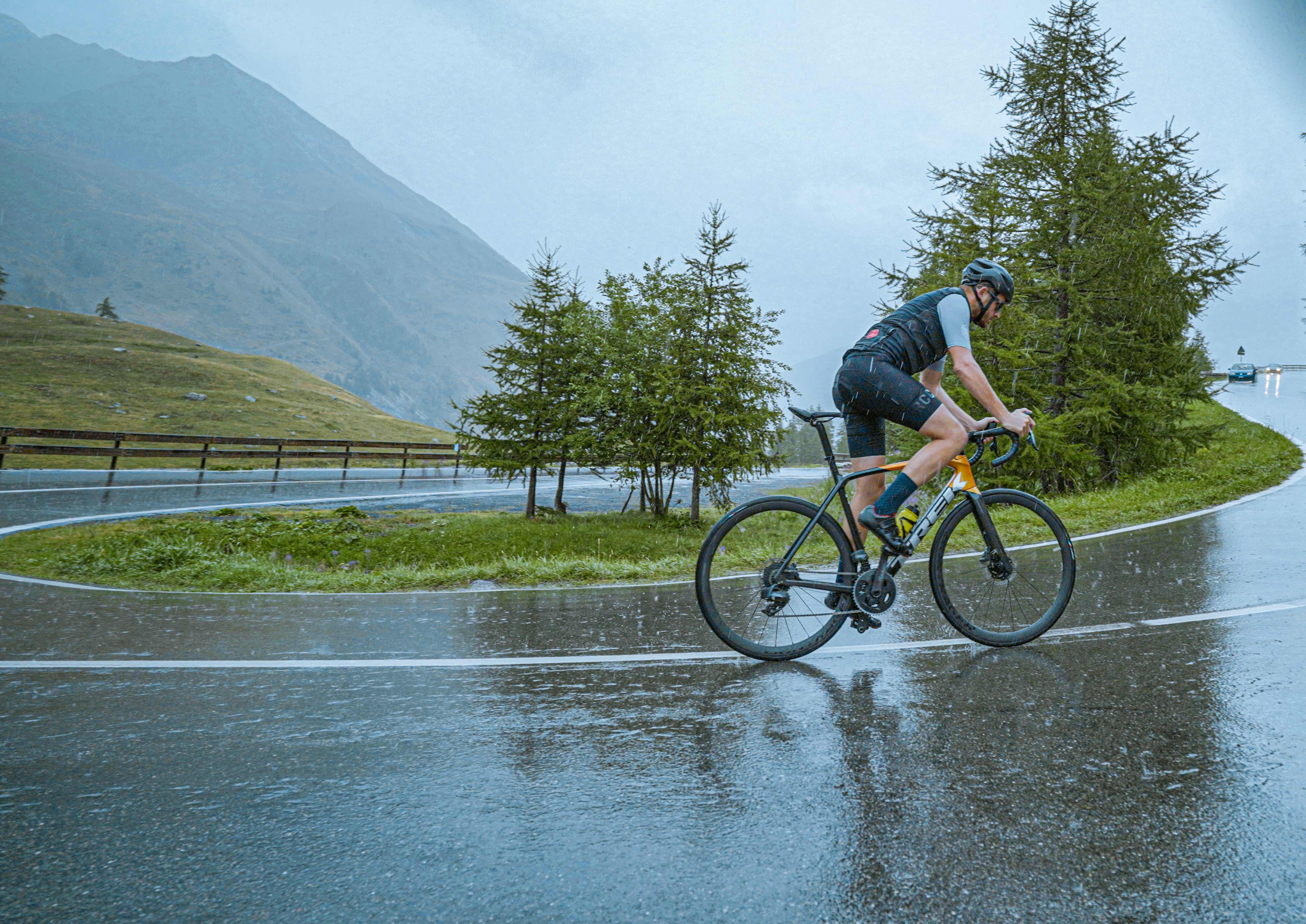 Cyclist riding a road bike outdoors in real conditions.