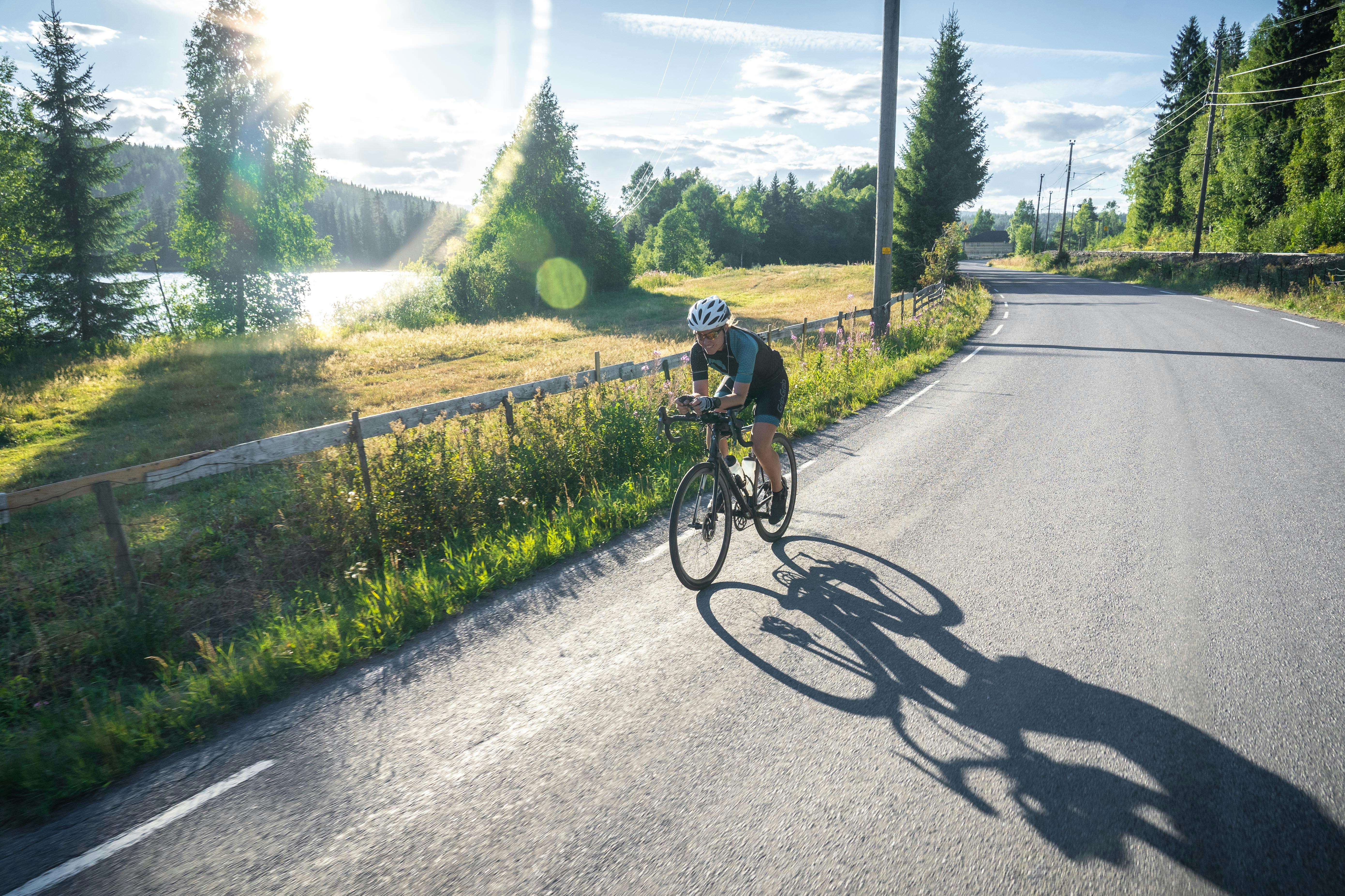 Cyclist riding a road bike outdoors in real conditions.