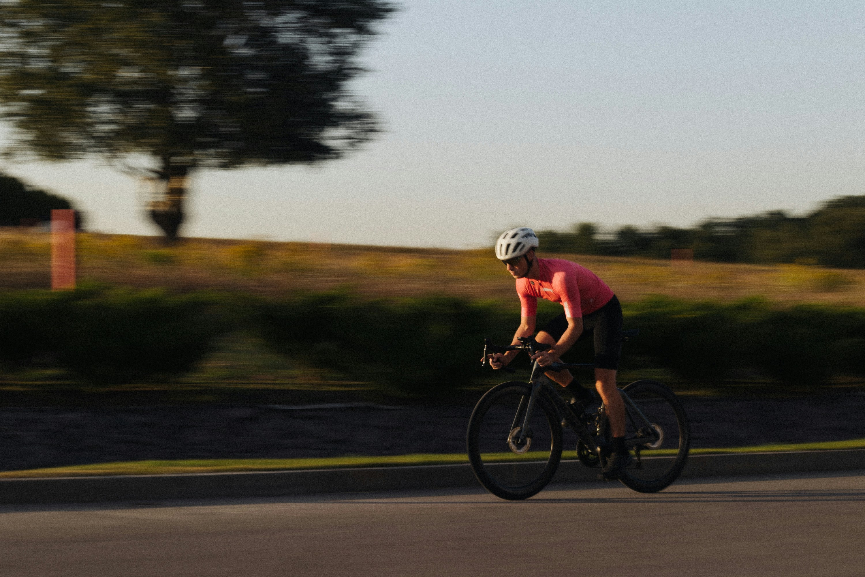 Cyclist riding a road bike outdoors in real conditions.