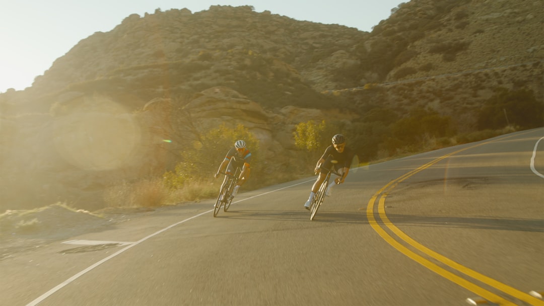 Group of road cyclists riding together outdoors on paved roads.