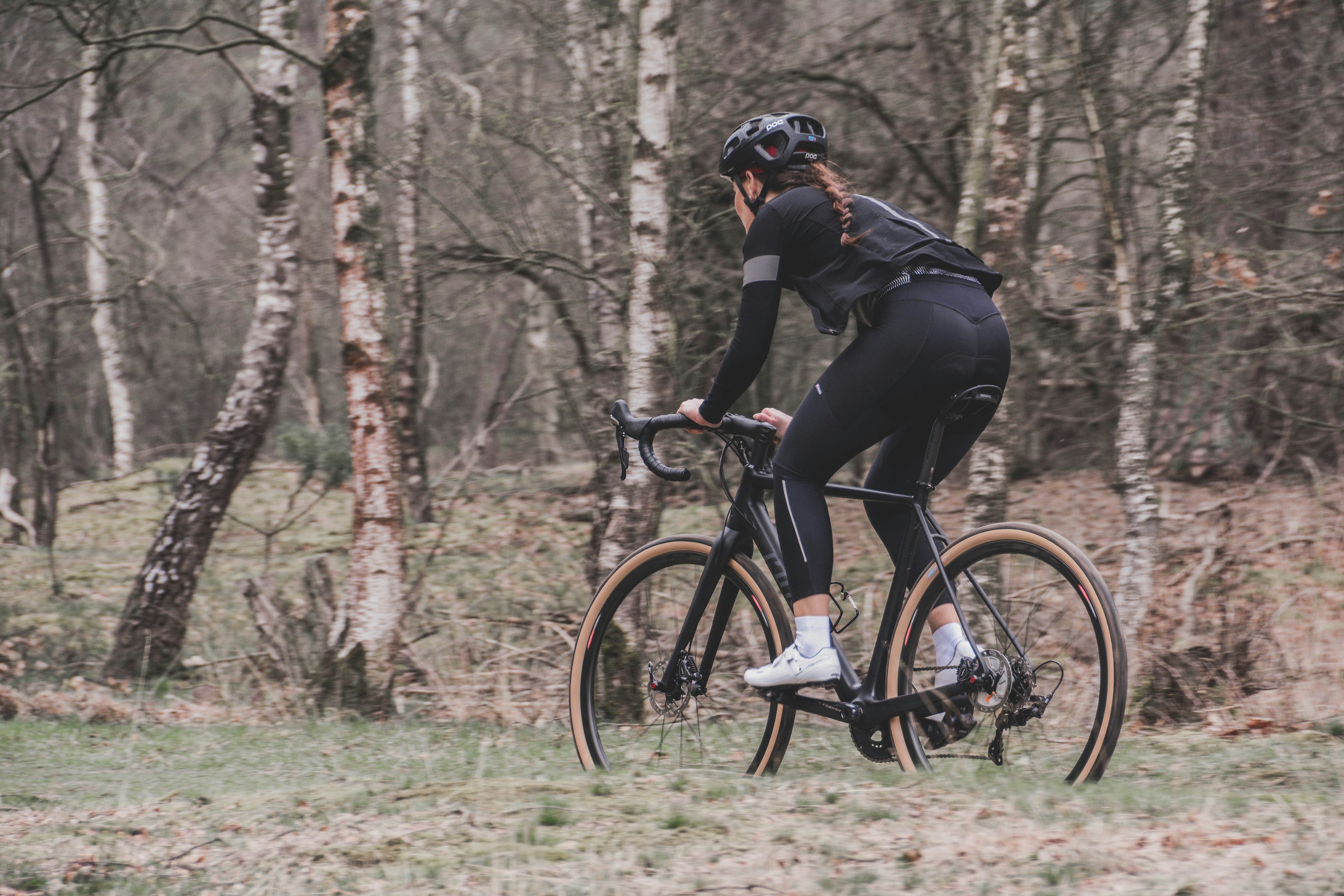 Cyclist riding a road bike outdoors in real conditions.