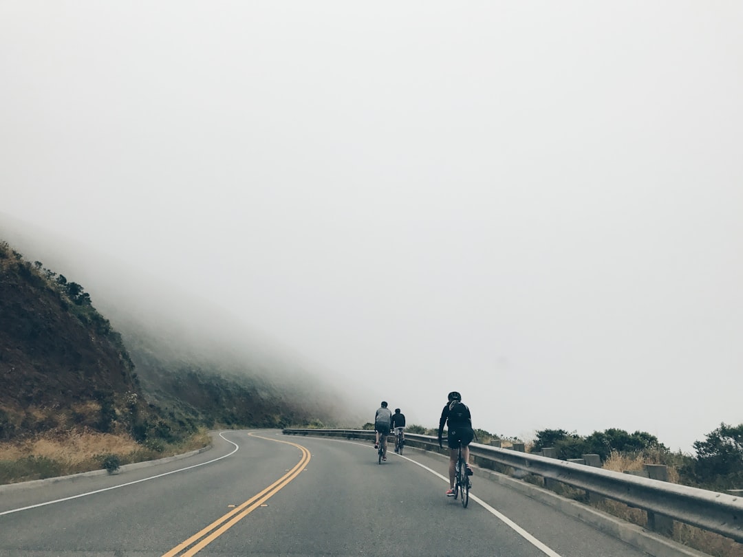 Group of road cyclists riding together outdoors on paved roads.