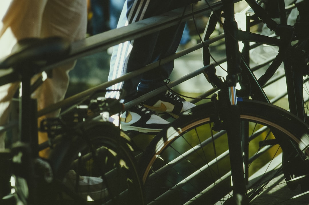 Close-up of a cyclist pedaling on a road bike with a power meter visible.