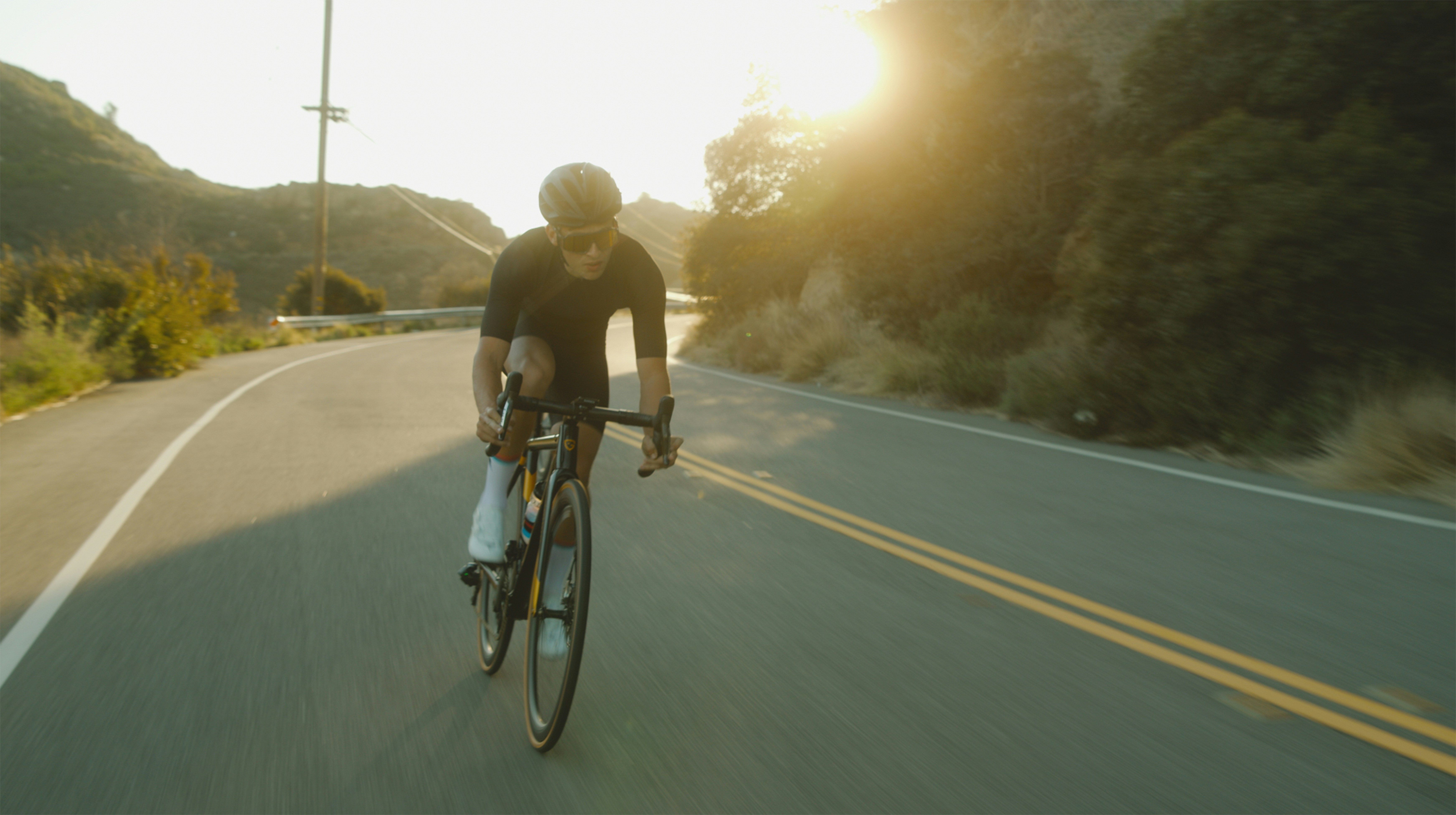 Cyclist riding a road bike outdoors in real conditions.
