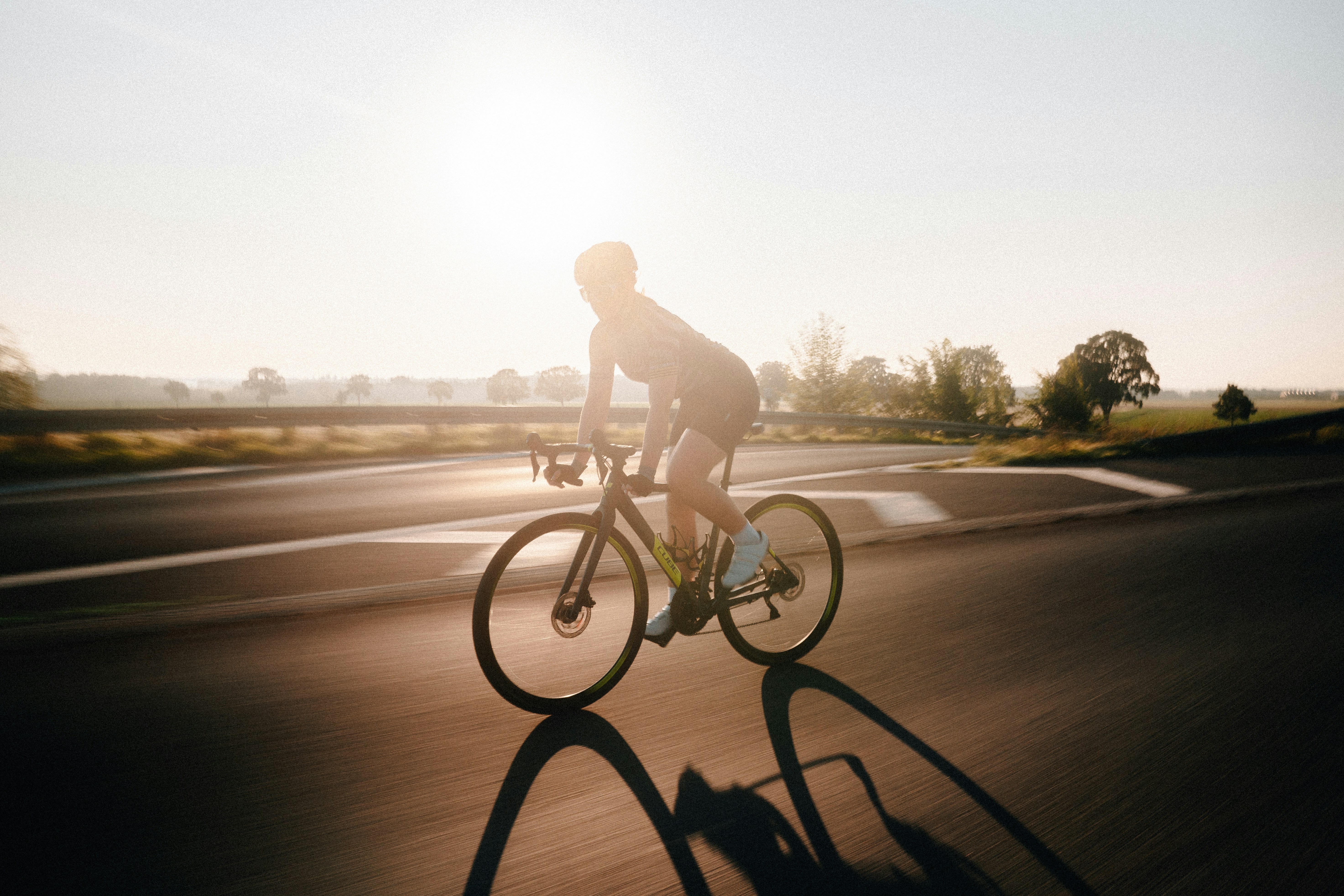 Cyclist riding a road bike outdoors in real conditions.
