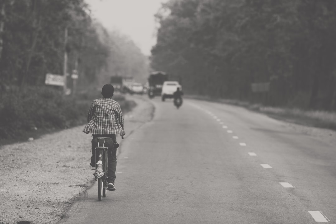Group of road cyclists riding together outdoors on paved roads.