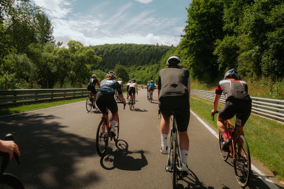 Group of road cyclists riding together outdoors on paved roads.