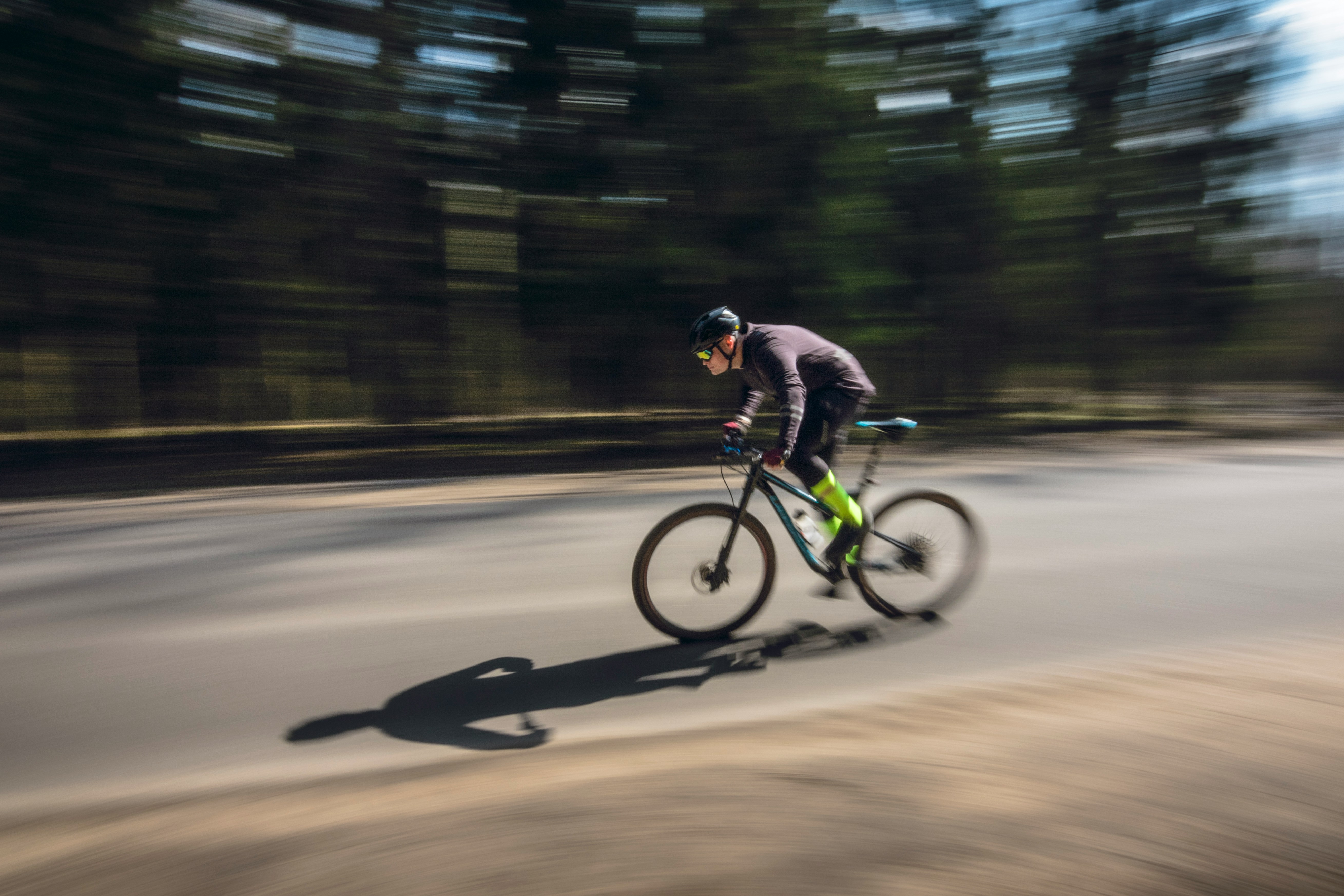 Cyclist riding a road bike outdoors in real conditions.