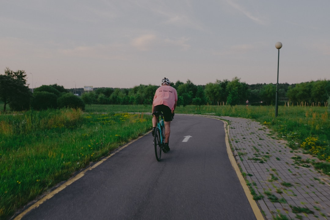 Group of road cyclists riding together outdoors on paved roads.