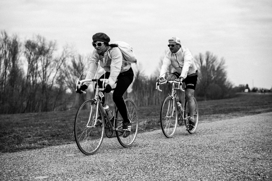 Group of road cyclists riding together outdoors on paved roads.