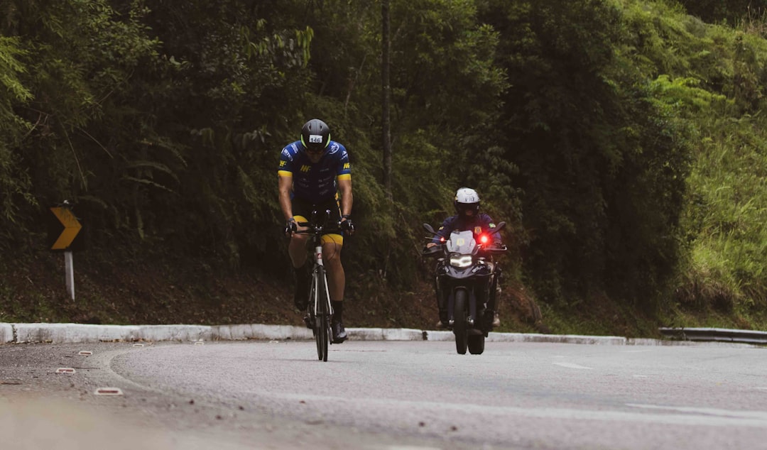 Group of road cyclists riding together outdoors on paved roads.