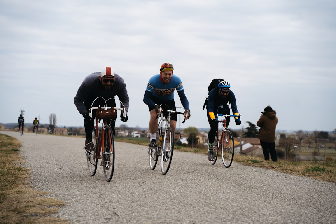 Group of road cyclists riding together outdoors on paved roads.