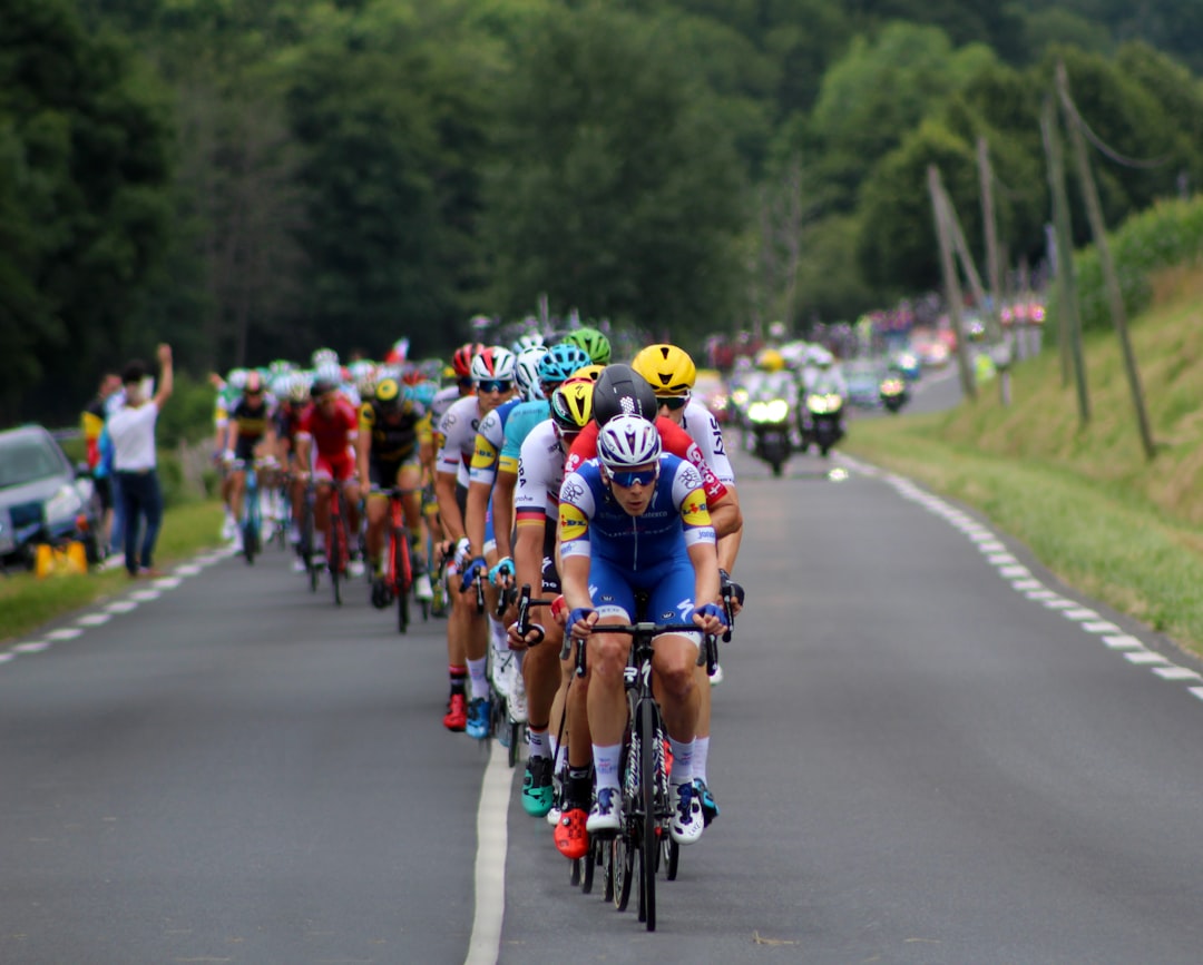 Group of road cyclists riding together outdoors on paved roads.