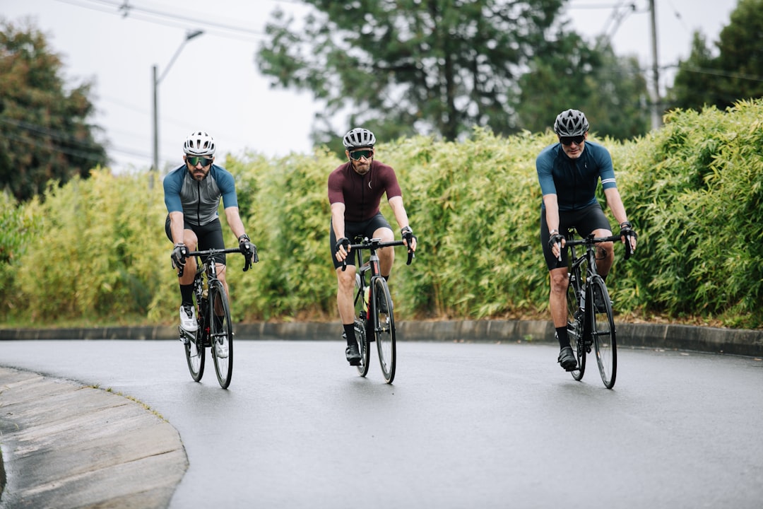 Group of road cyclists riding together outdoors on paved roads.