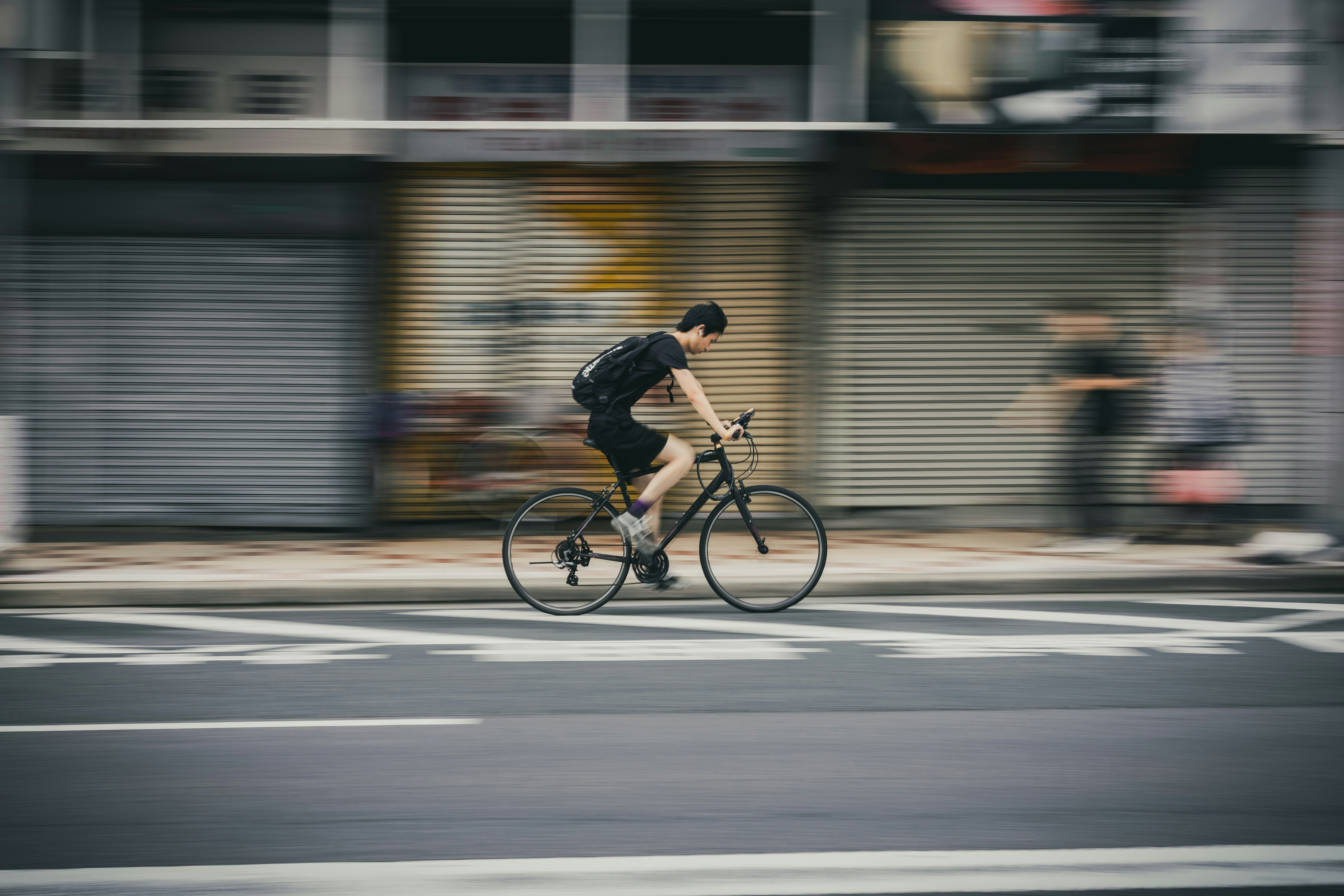 Cyclist riding a road bike outdoors in real conditions.
