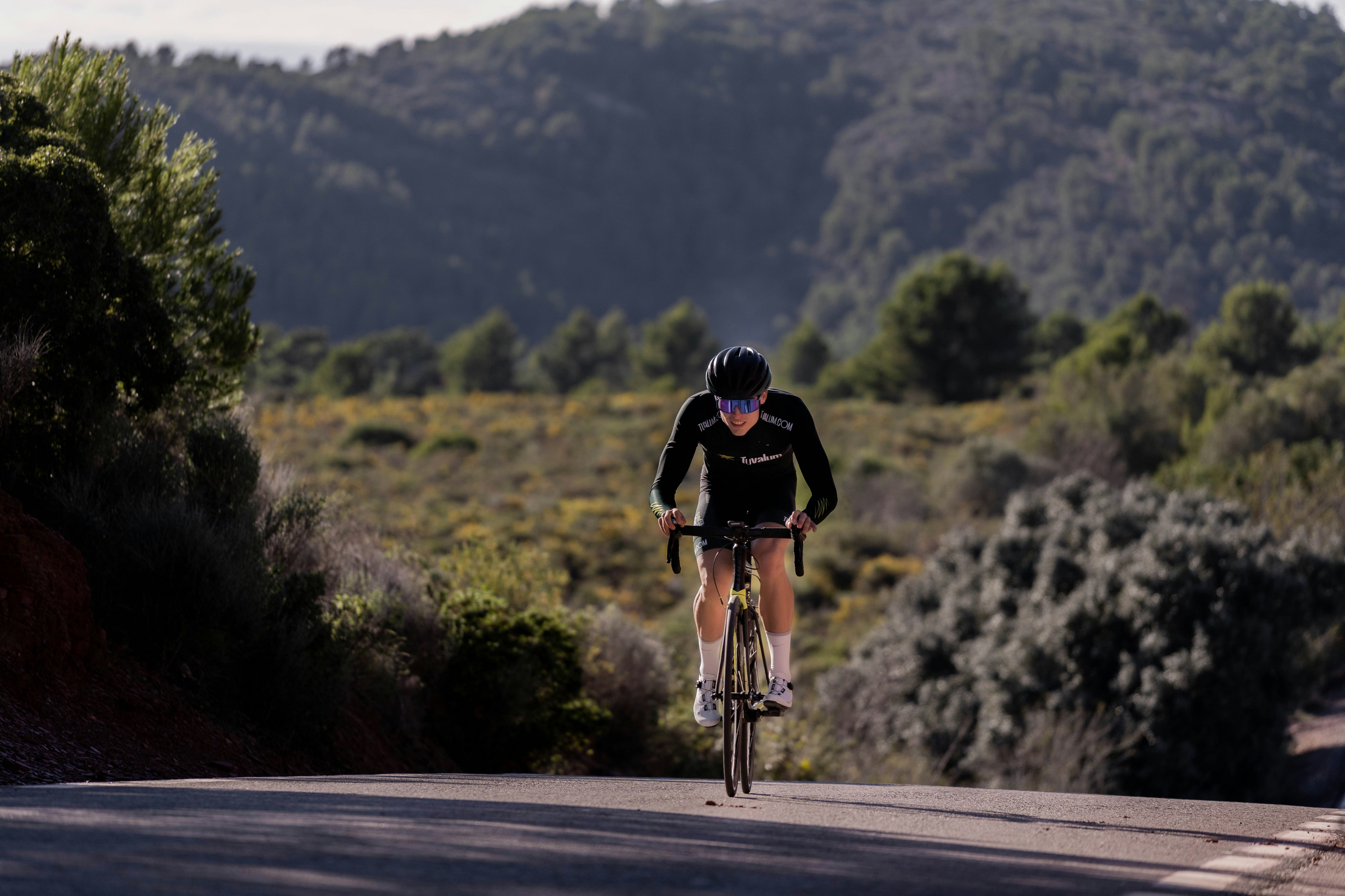Cyclist riding a road bike outdoors in real conditions.