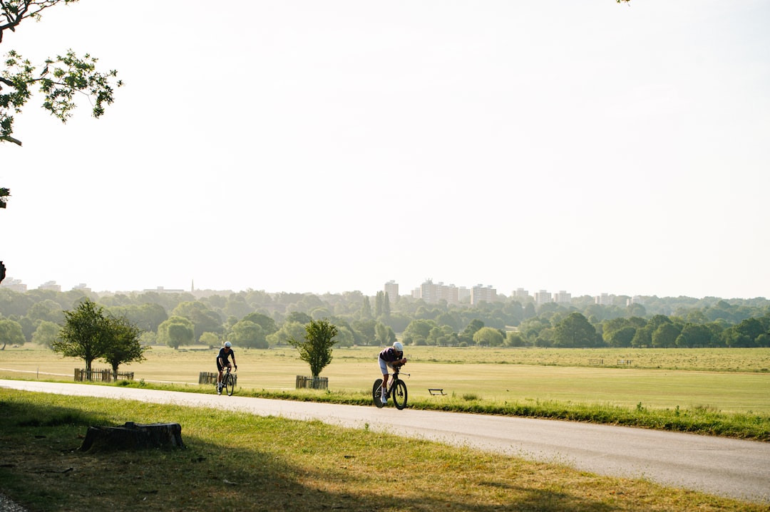 Group of road cyclists riding together outdoors on paved roads.
