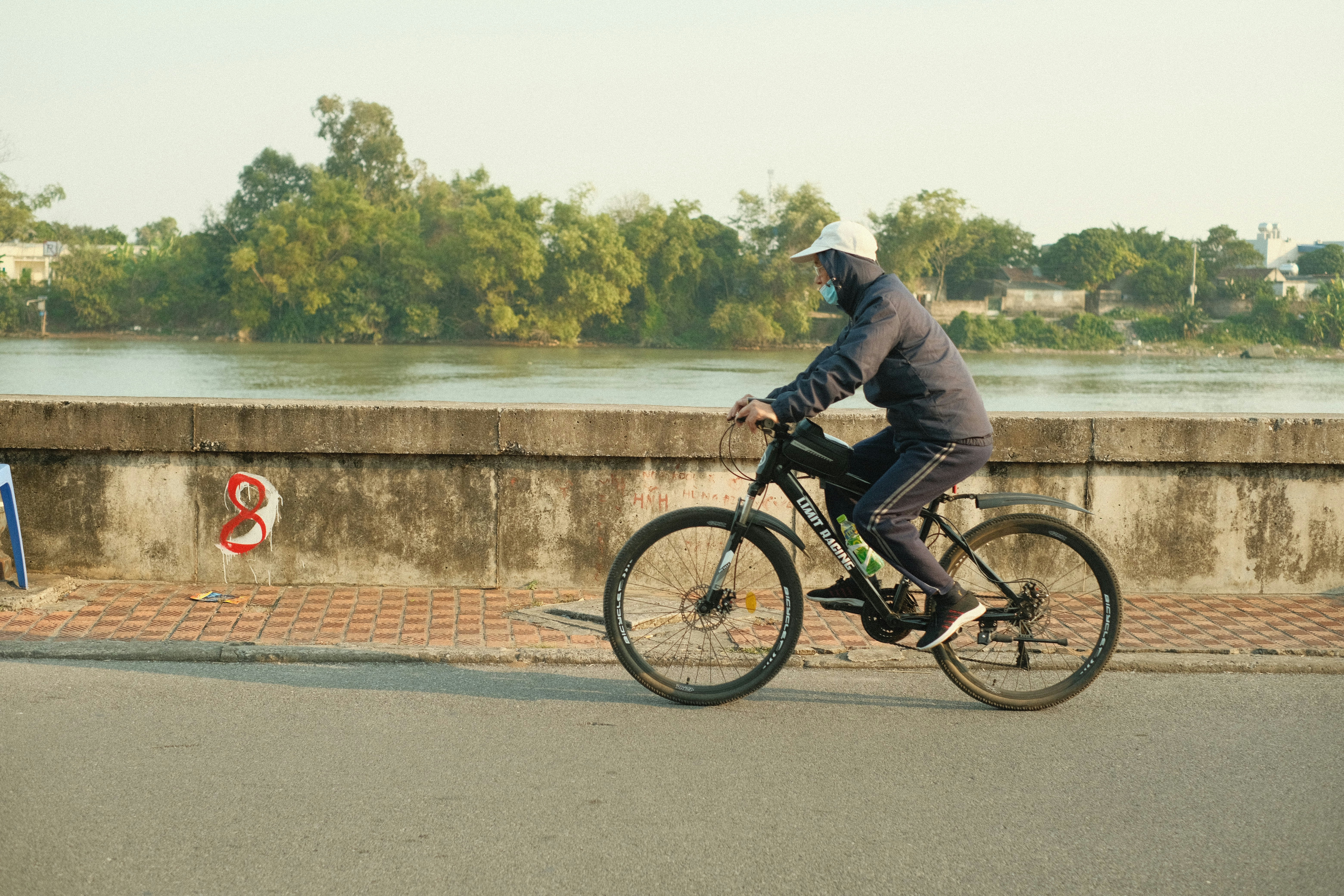 Cyclist riding a road bike outdoors in real conditions.