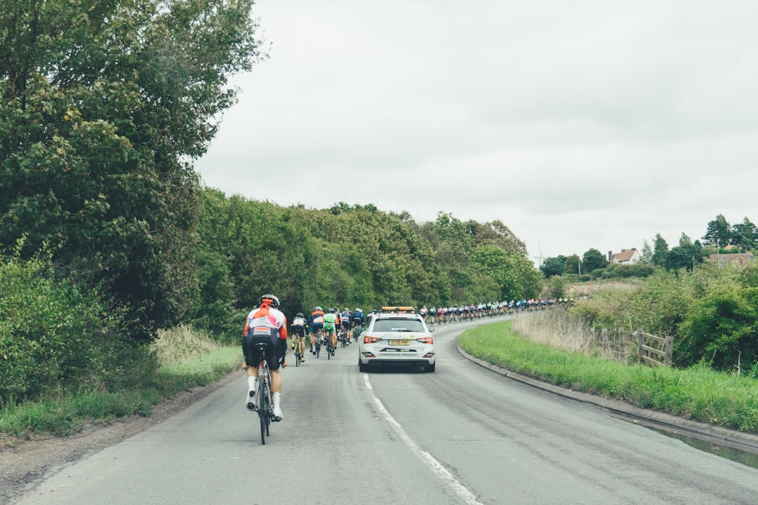 Group of road cyclists riding together outdoors on paved roads.