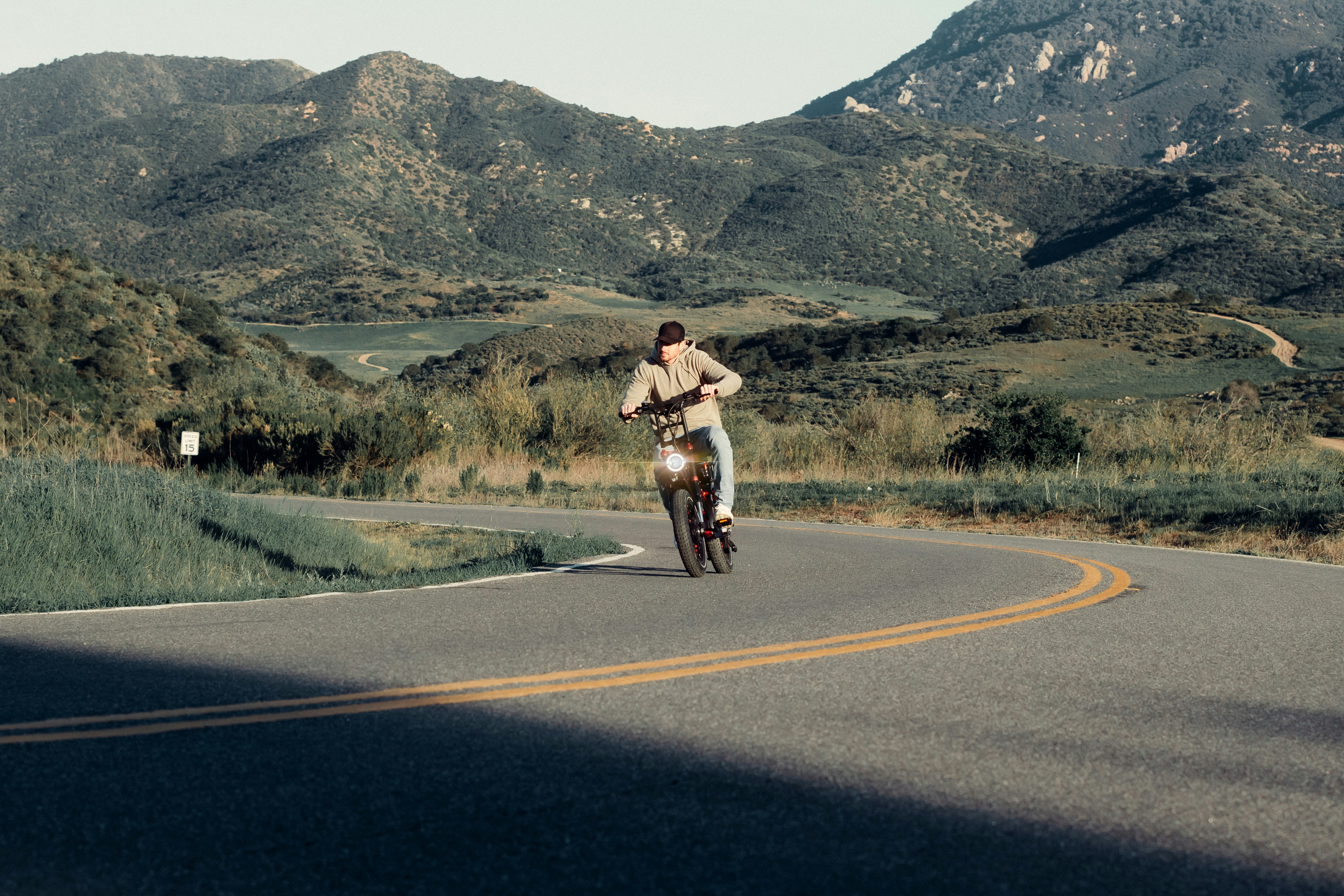 Cyclist riding a road bike outdoors in real conditions.