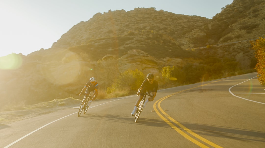 Group of road cyclists riding together outdoors on paved roads.