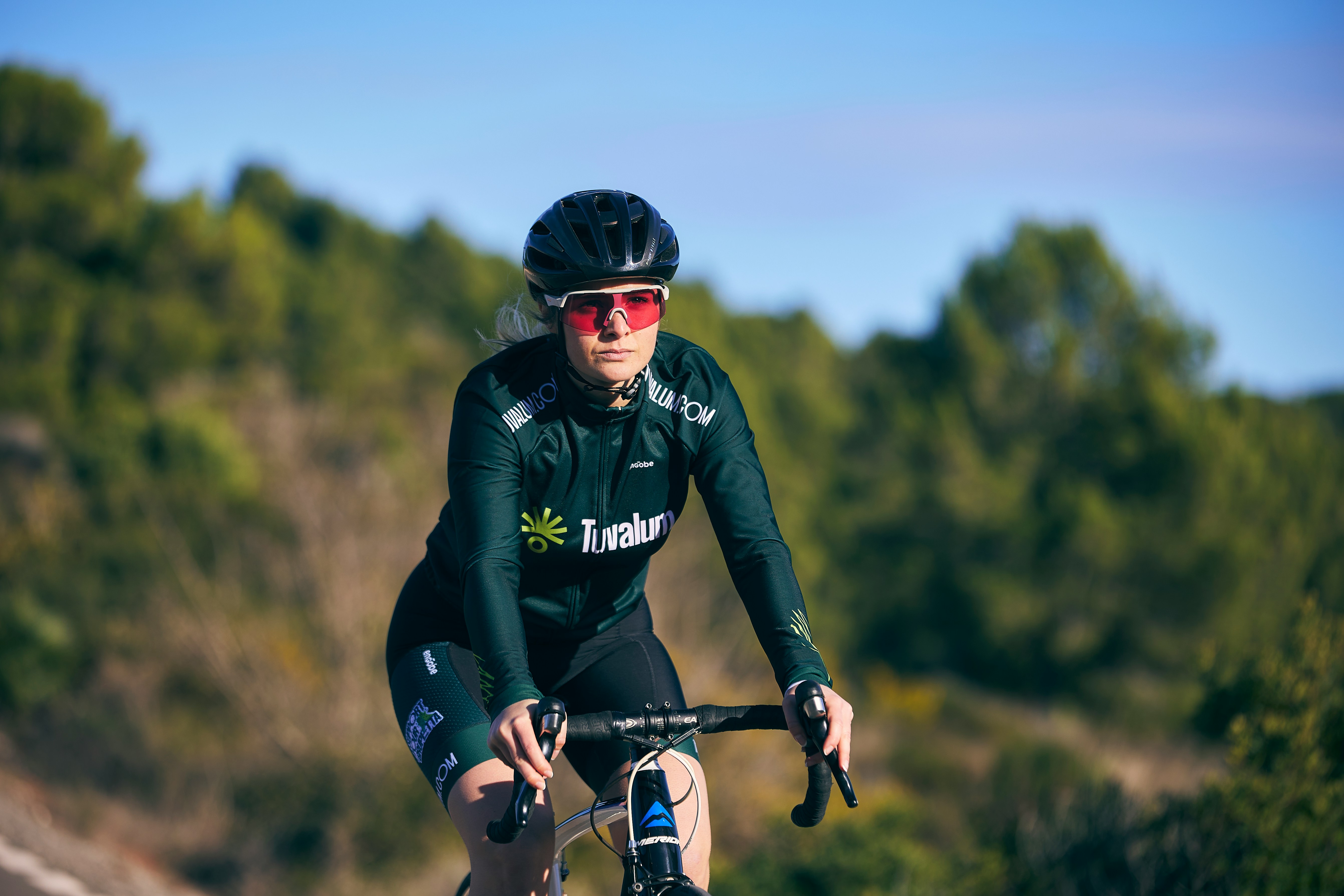 Cyclist riding a road bike outdoors in real conditions.