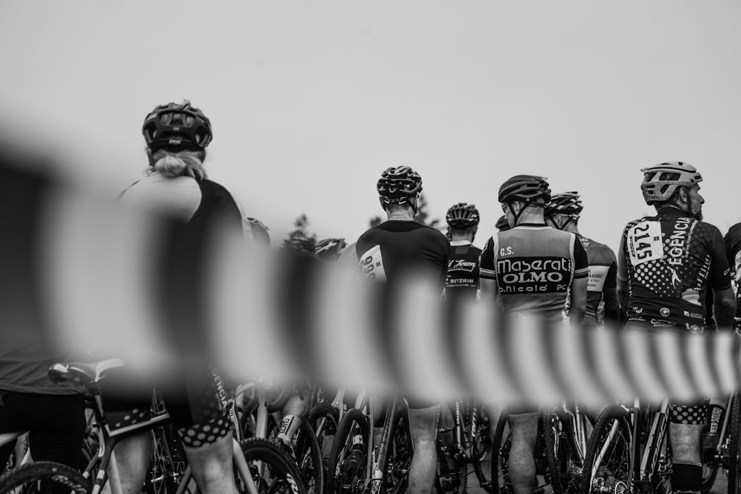 Group of road cyclists riding together outdoors on paved roads.