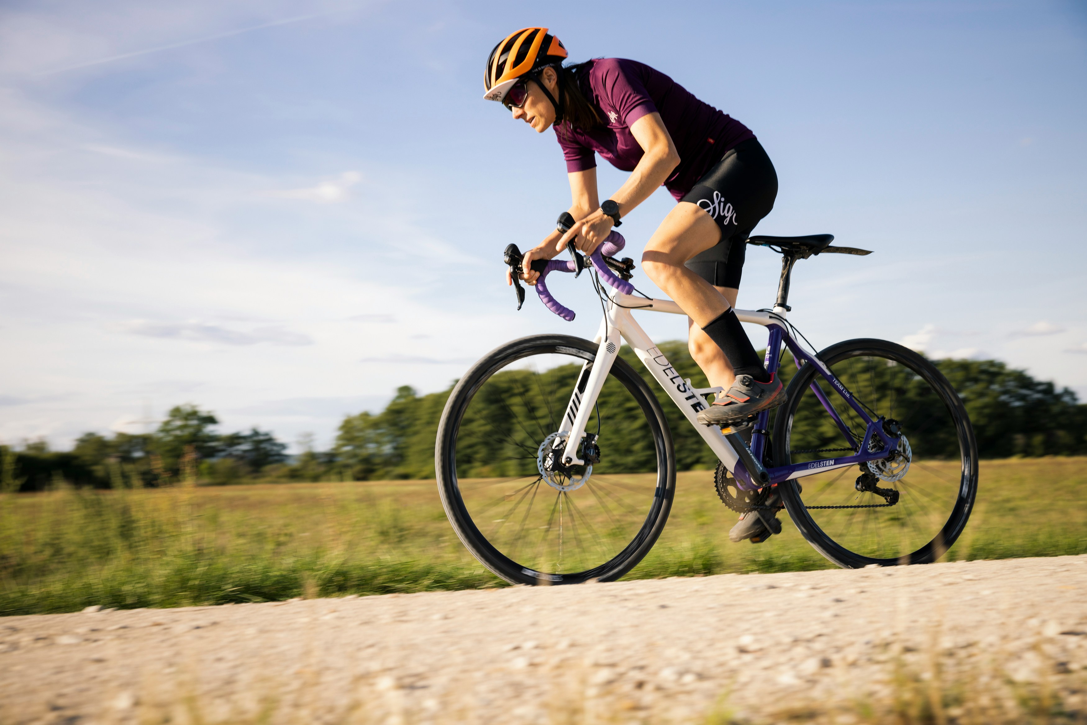 Cyclist riding a road bike outdoors in real conditions.