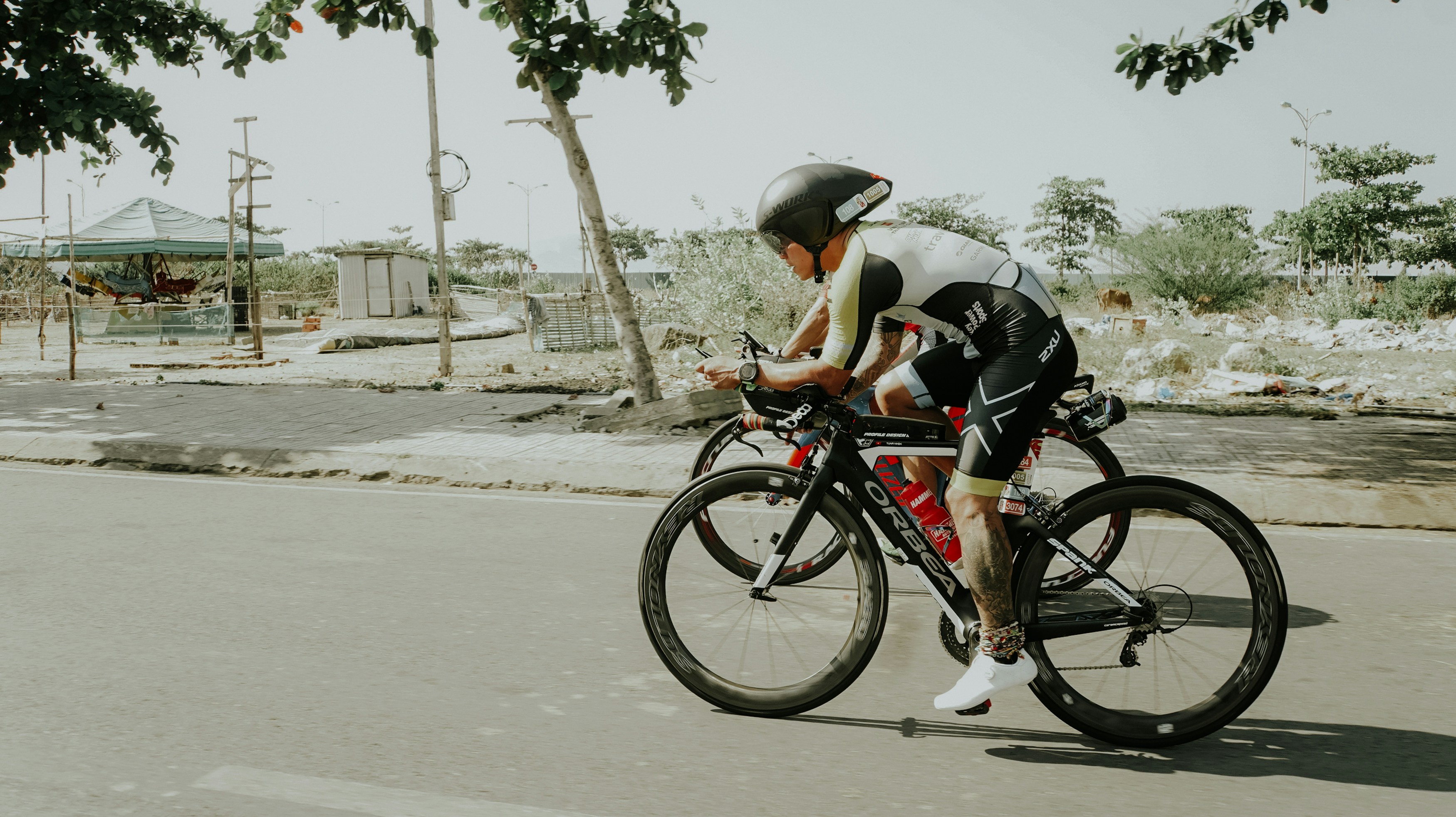 Cyclist riding a road bike outdoors in real conditions.