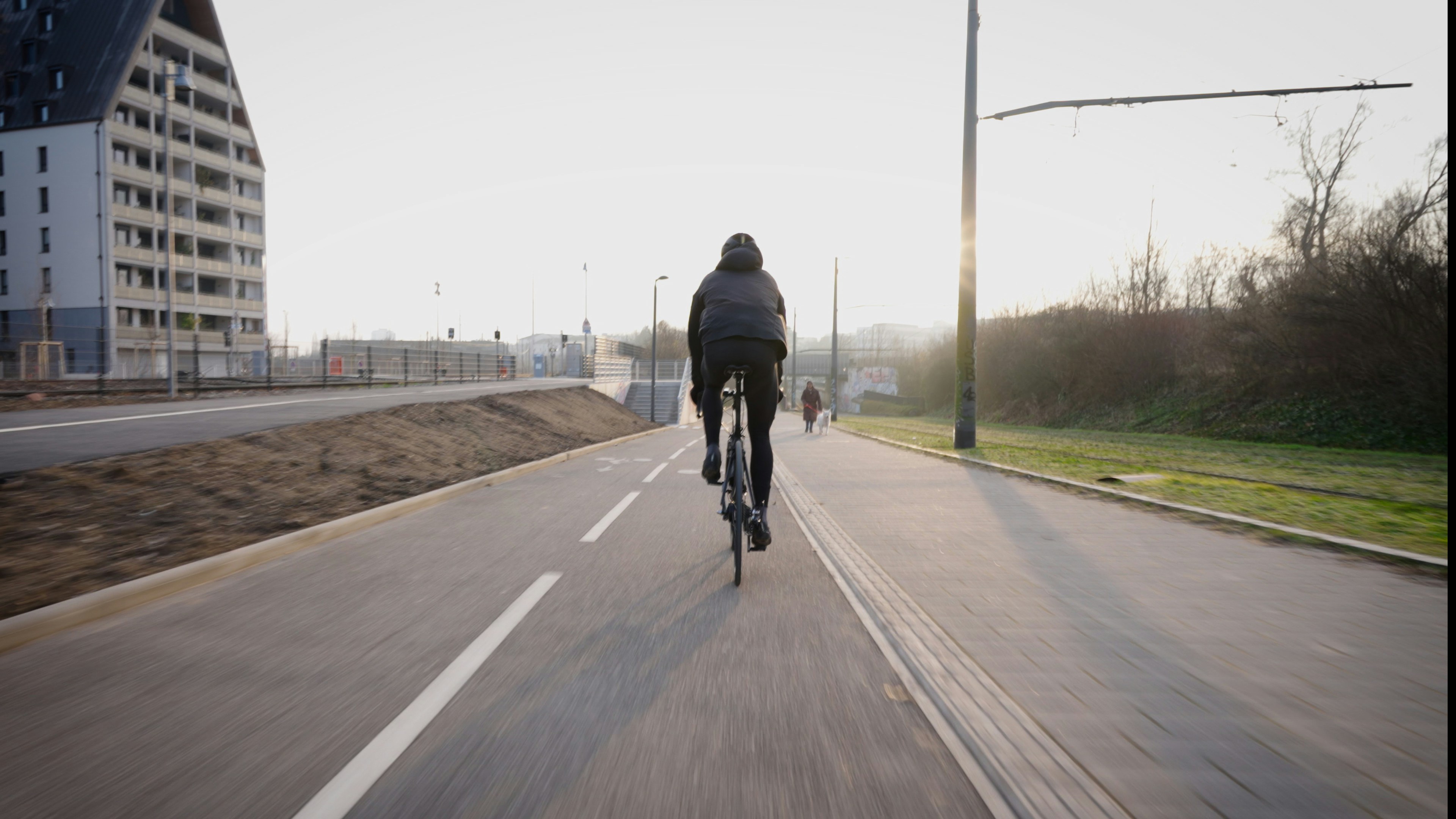 Cyclist riding a road bike outdoors in real conditions.