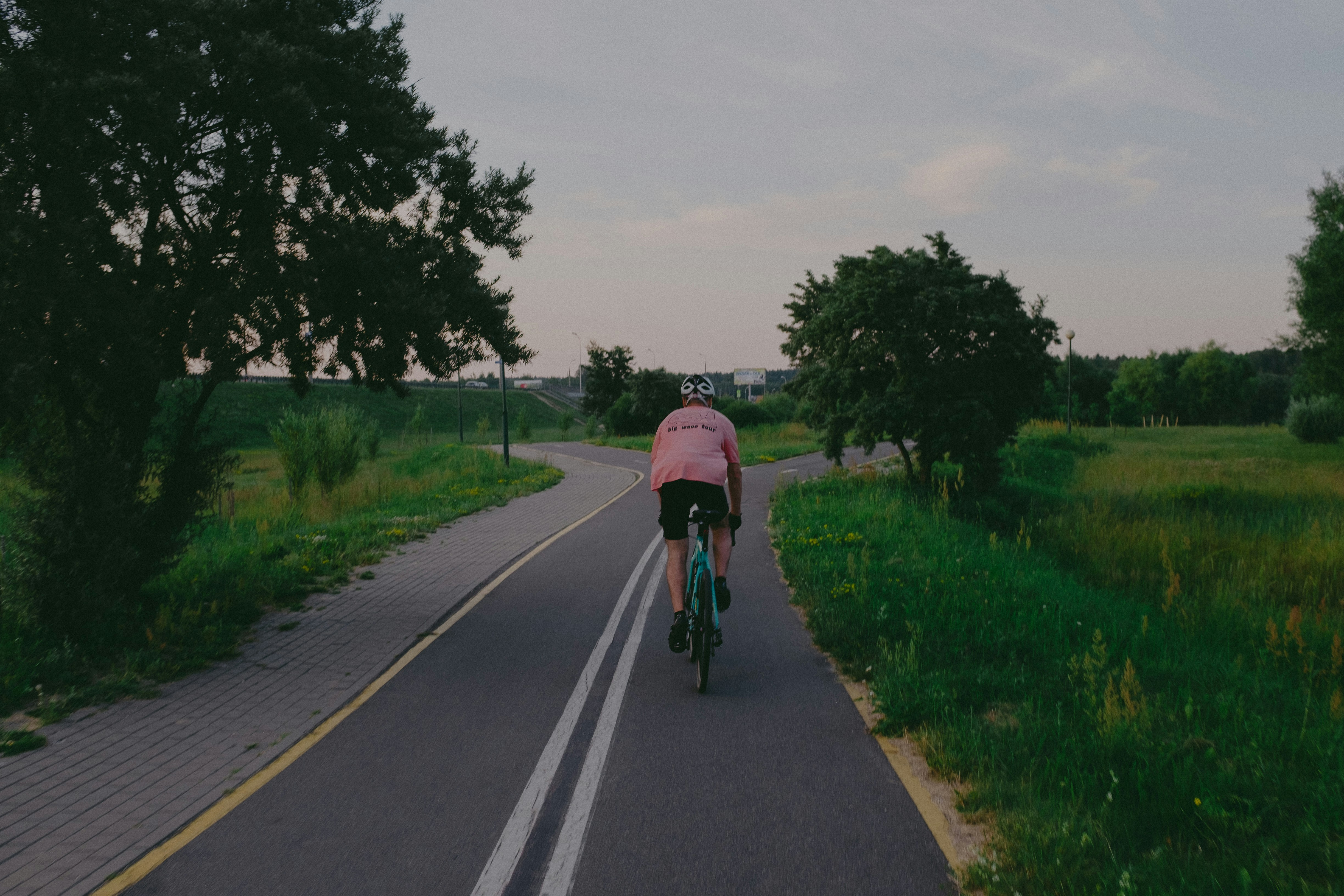 Cyclist riding a road bike outdoors in real conditions.