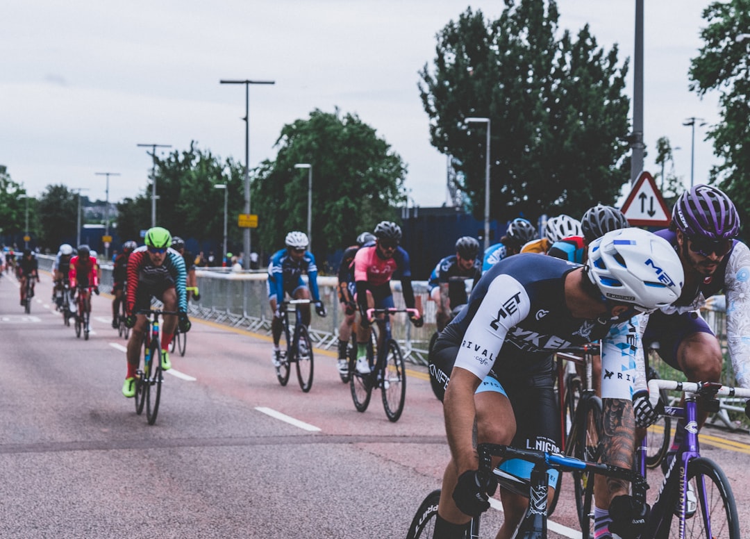 Group of road cyclists riding together outdoors on paved roads.