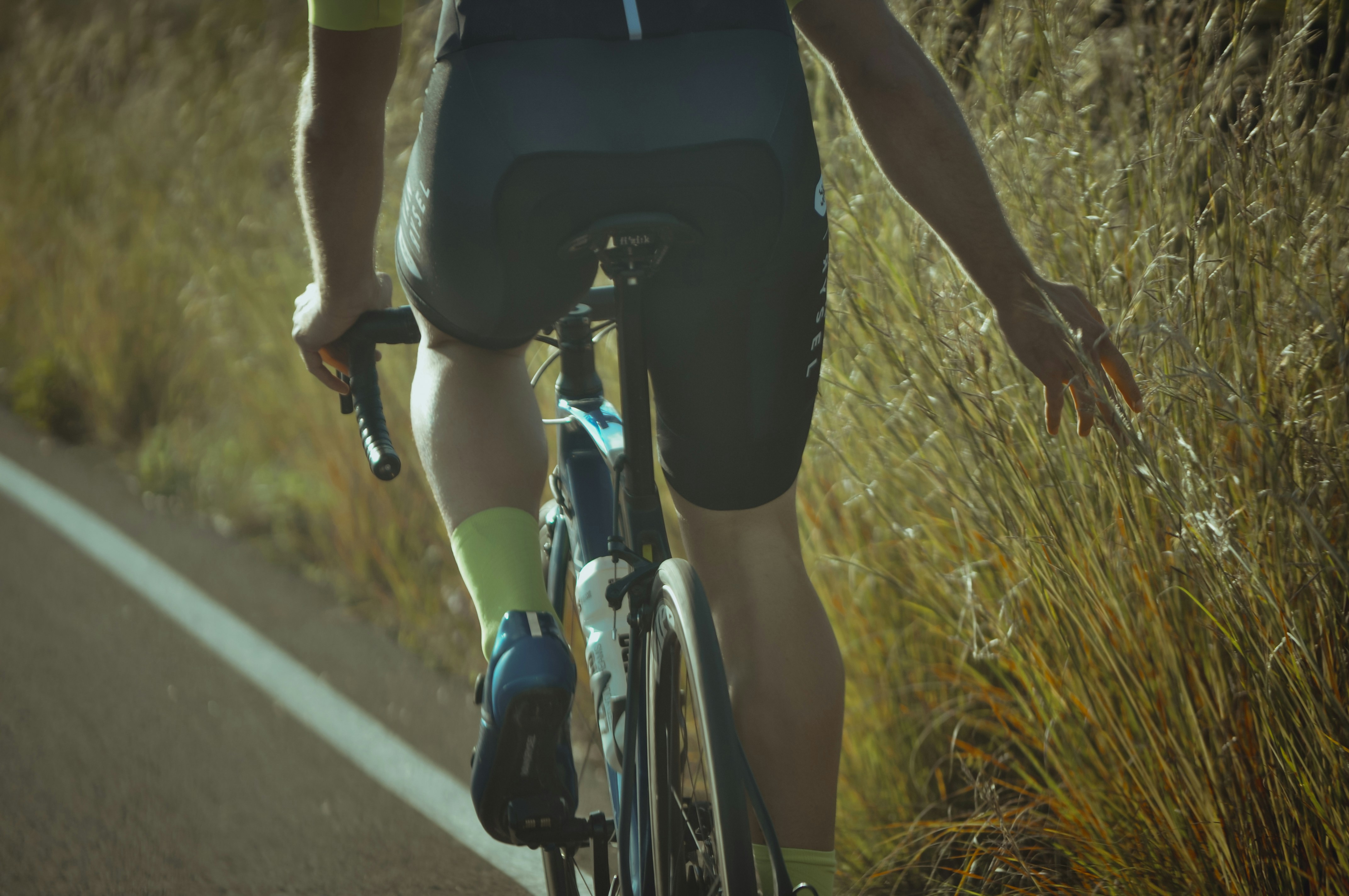 Cyclist riding a road bike outdoors in real conditions.