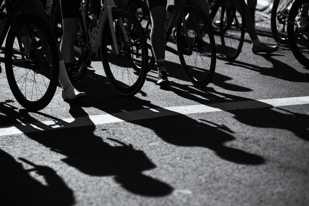 Group of road cyclists riding together outdoors on paved roads.