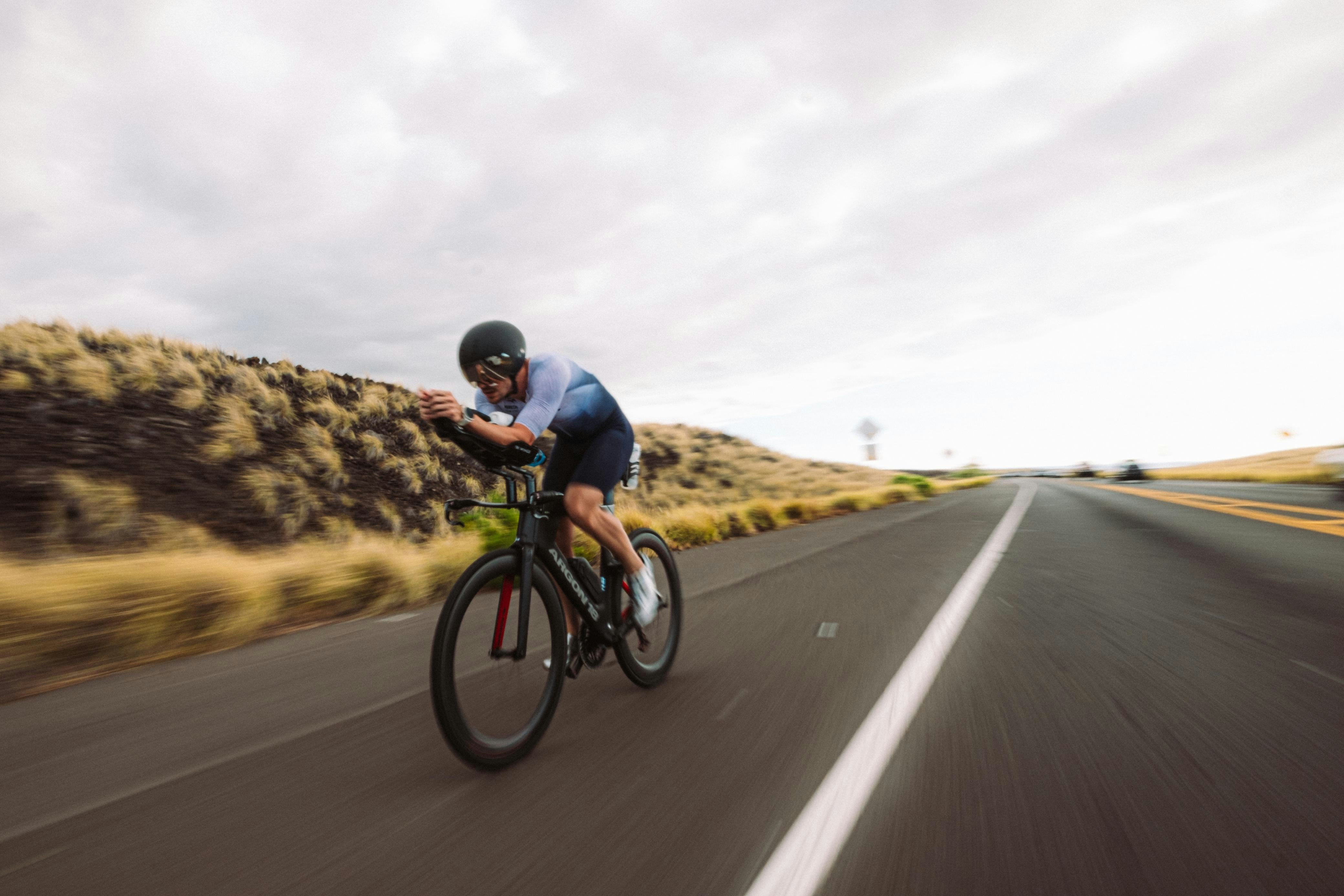 Cyclist riding a road bike outdoors in real conditions.