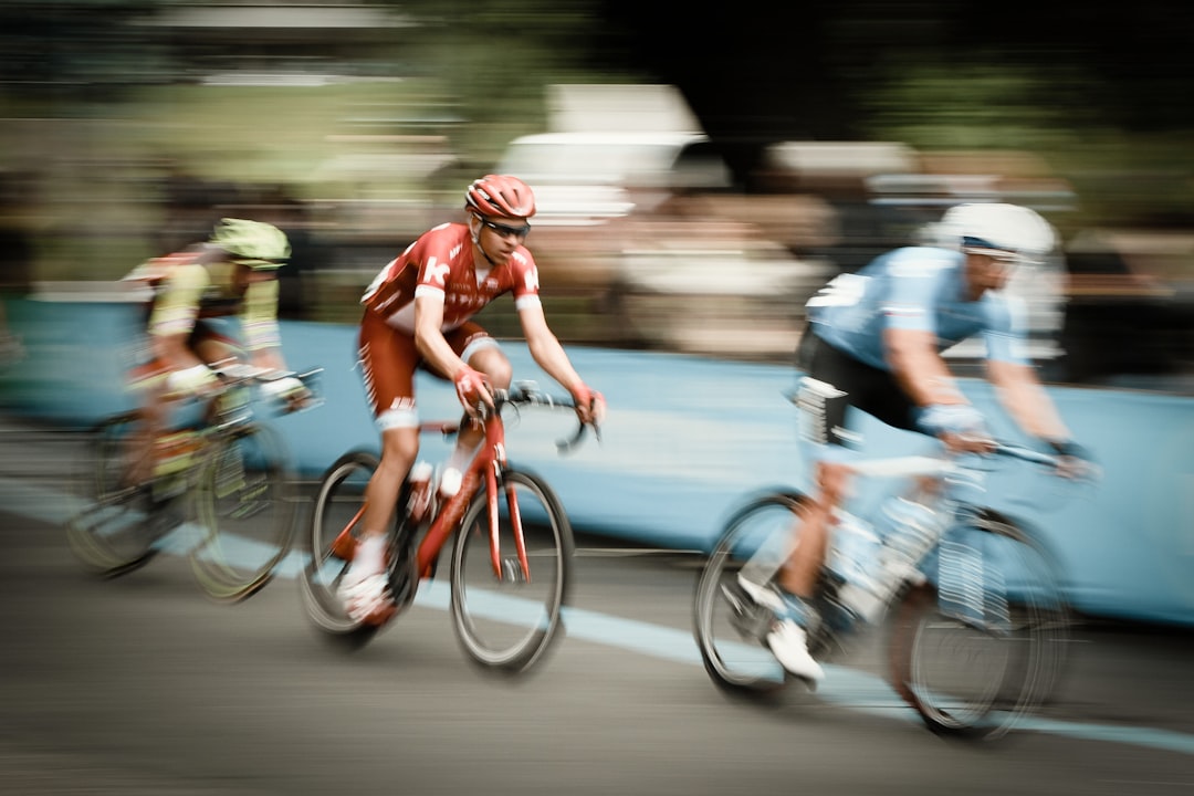 Group of road cyclists riding together outdoors on paved roads.