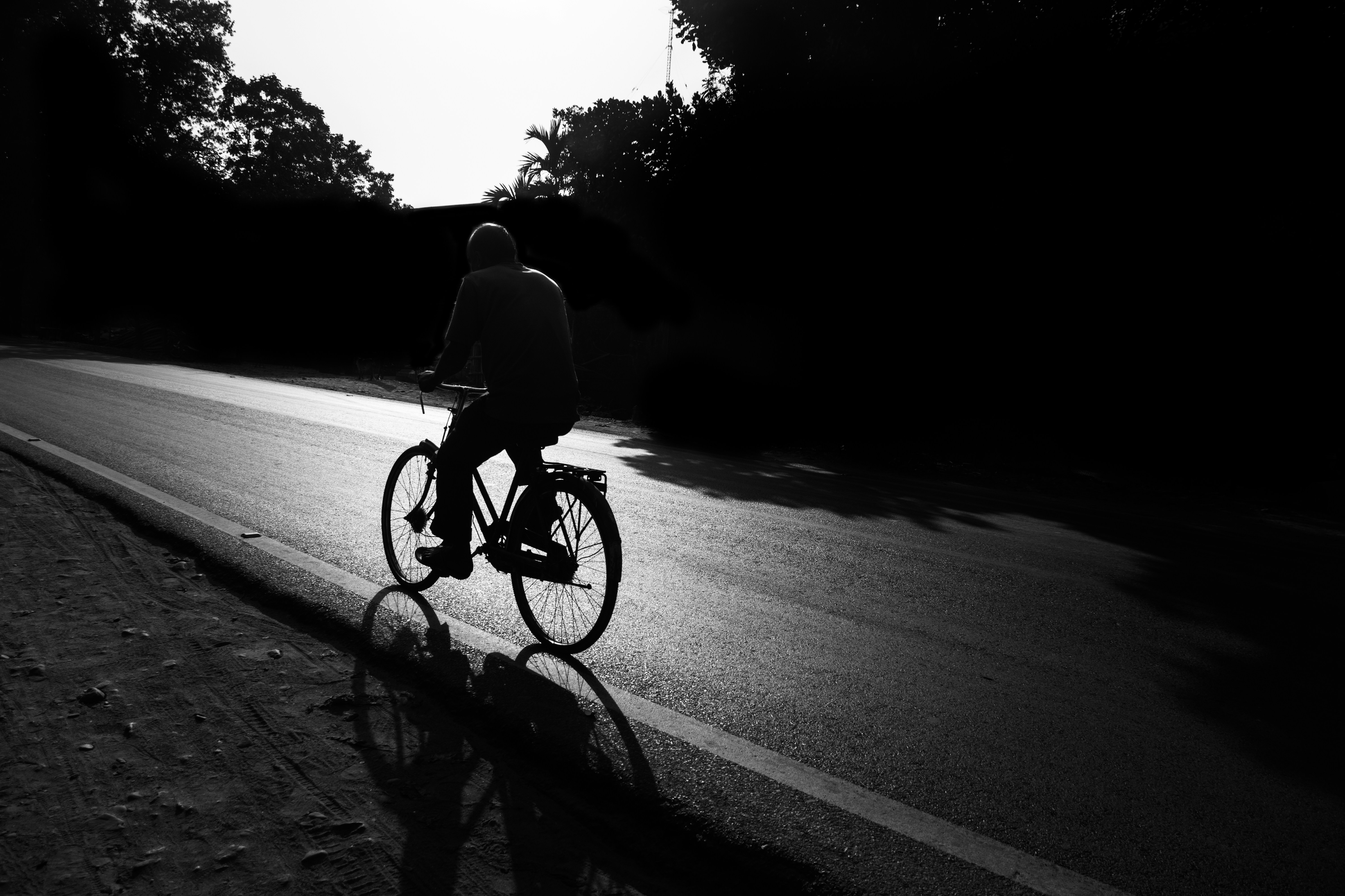 Cyclist riding a road bike outdoors in real conditions.