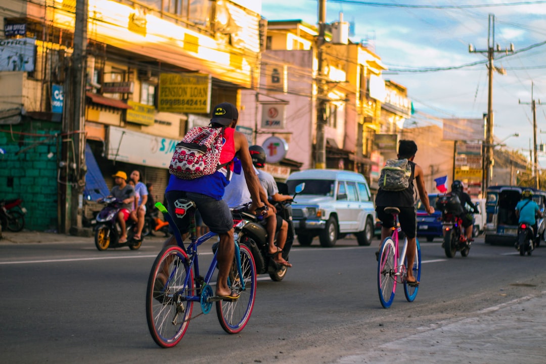 Group of road cyclists riding together outdoors on paved roads.