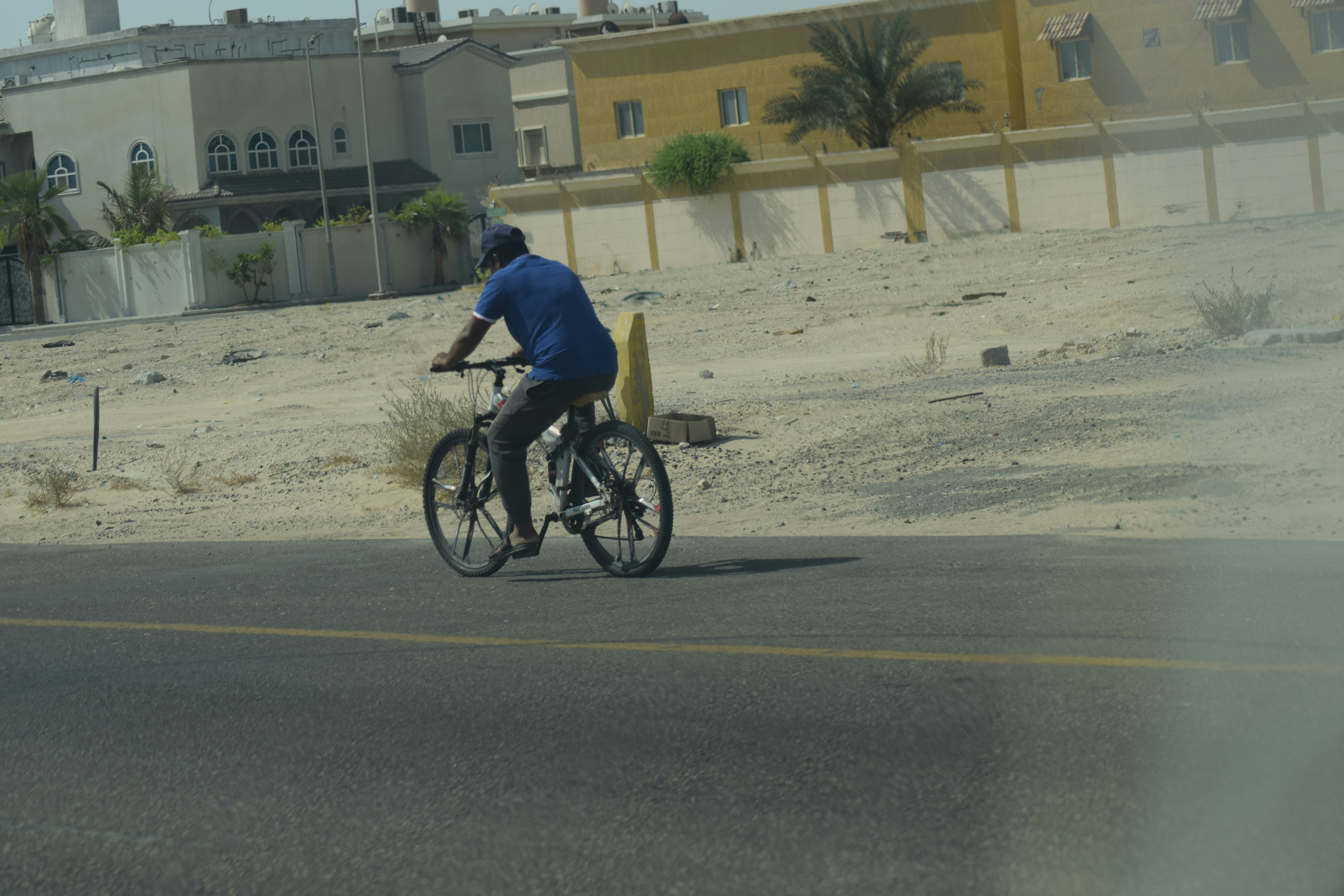 Cyclist riding a road bike outdoors in real conditions.