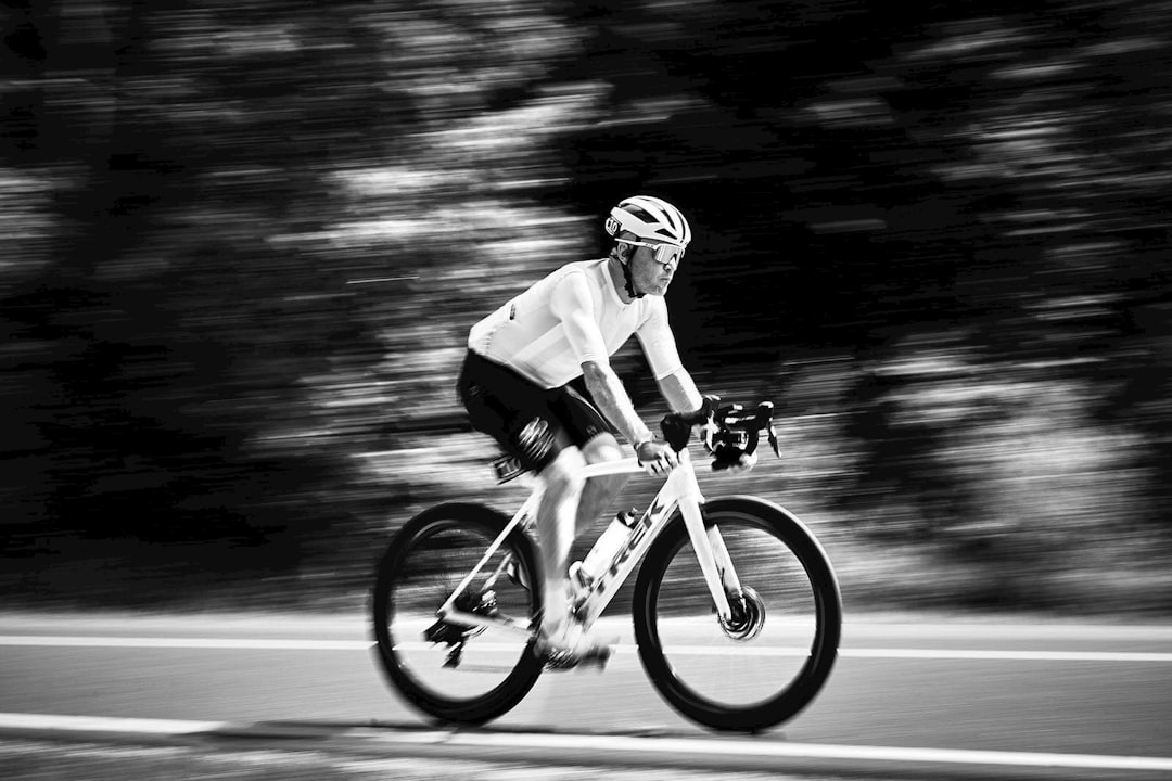 Group of road cyclists riding together outdoors on paved roads.