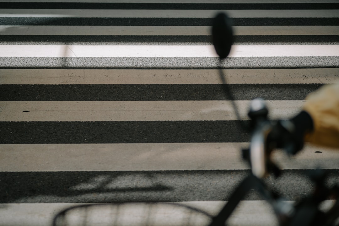 Close-up of a cyclist pedaling on a road bike with a power meter visible.