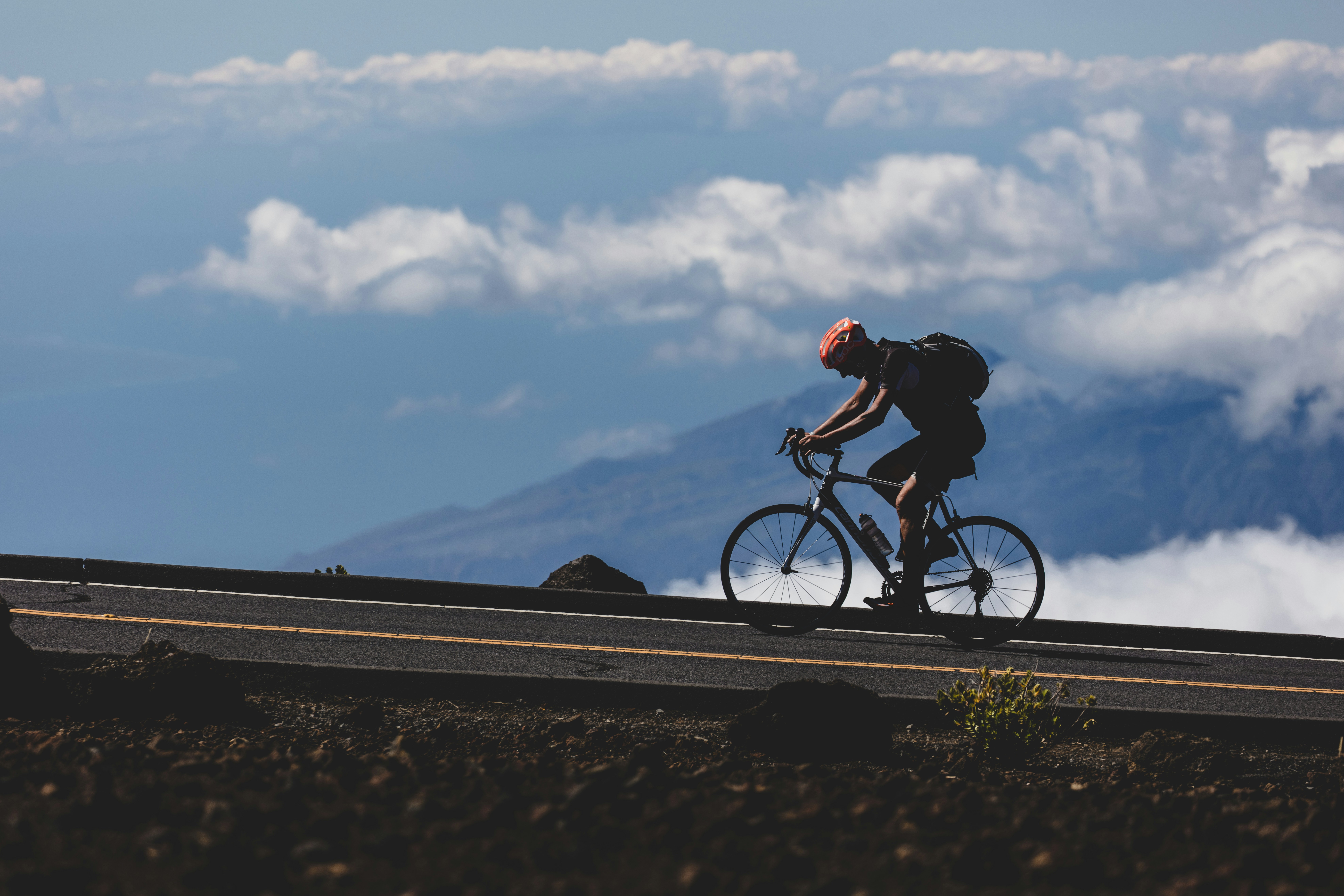 Cyclist riding a road bike outdoors in real conditions.